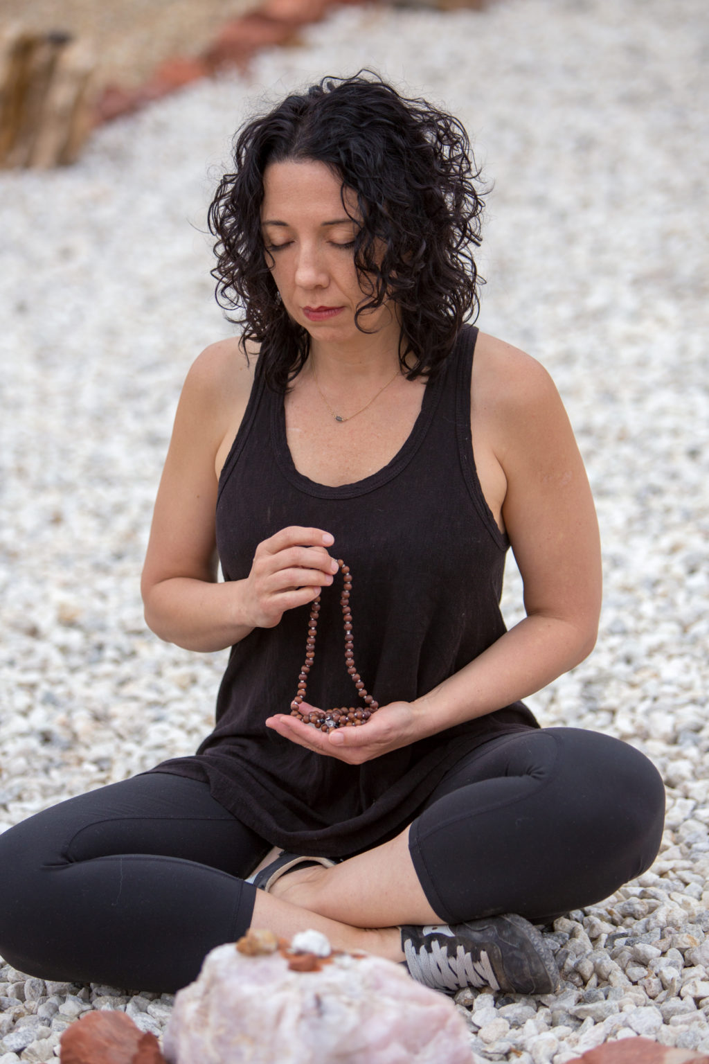 Woman meditating with prayer beads