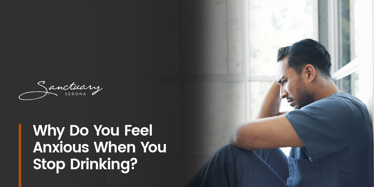 a man sits in front of a window with the words why do you feel anxious when you stop drinking